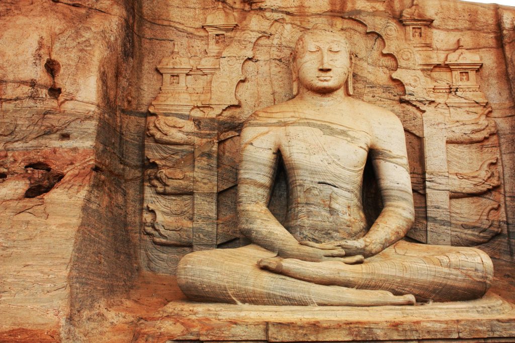 A carved statue of Buddha in a meditative pose at the Gal Vihara temple in Sri Lanka.